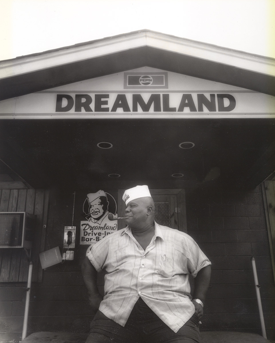Founder John "Big Daddy" Bishop sitting in front of the Tuscaloosa Dreamland BBQ